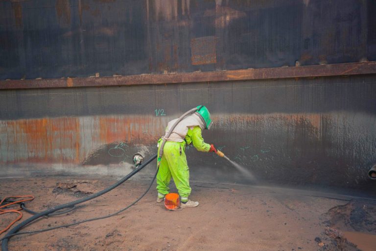 female-worker-surface-corrosion-plate-preparation-by-sand-blasting